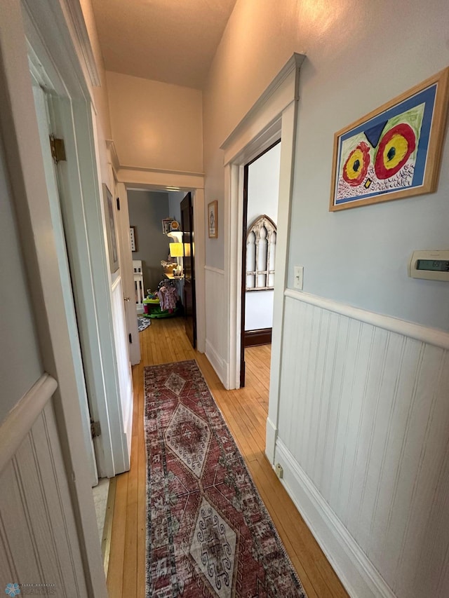 911 8th St N, Fargo, ND 58102 - hallway with light wood finished floors and wainscoting