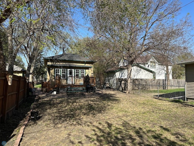 911 8th St N, Fargo, ND 58102 - view of yard featuring a fenced backyard and a wooden deck