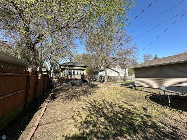 911 8th St N, Fargo, ND 58102 - view of yard featuring a trampoline, fence, and a wooden deck