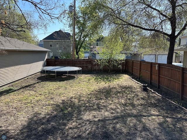 911 8th St N, Fargo, ND 58102 - view of yard featuring a trampoline and a fenced backyard
