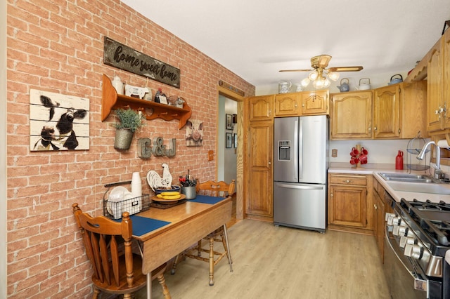 11438 Zea St NW, Coon Rapids, MN 55433 - kitchen featuring appliances with stainless steel finishes, a sink, a ceiling fan, light wood-style flooring, and light countertops
