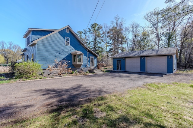 view of side of home featuring an outdoor structure and a garage