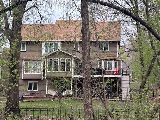back of house featuring a sunroom and a deck