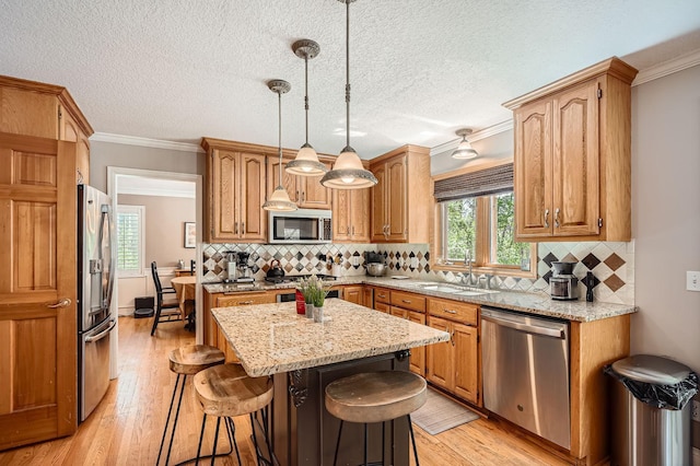 1237 Summit Oaks Dr, Burnsville, MN 55337 - kitchen featuring stainless steel appliances, light wood-style floors, crown molding, a center island, and a kitchen bar
