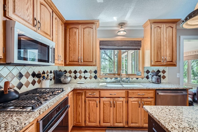 1237 Summit Oaks Dr, Burnsville, MN 55337 - kitchen with stainless steel appliances, light stone counters, backsplash, and a textured ceiling
