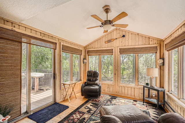 1237 Summit Oaks Dr, Burnsville, MN 55337 - sunroom / solarium featuring lofted ceiling, wood walls, wood finished floors, a textured ceiling, and a baseboard heating unit