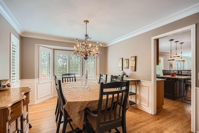 1237 Summit Oaks Dr, Burnsville, MN 55337 - dining room featuring light wood-style flooring, crown molding, a chandelier, a wainscoted wall, and a decorative wall