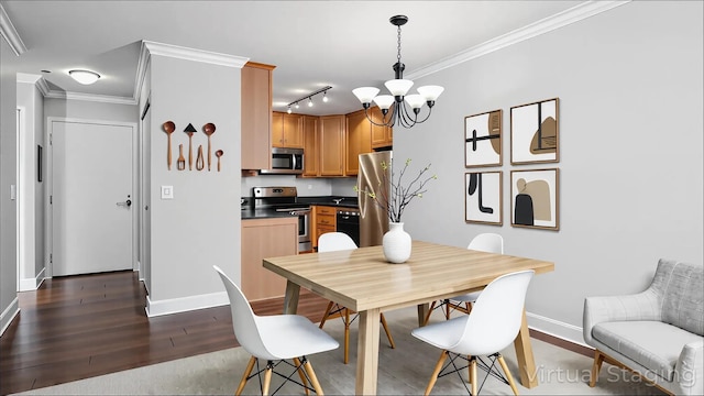 3540 Hennepin Ave Unit 309, Minneapolis, MN 55408 - dining room featuring baseboards, a chandelier, dark wood finished floors, rail lighting, and ornamental molding