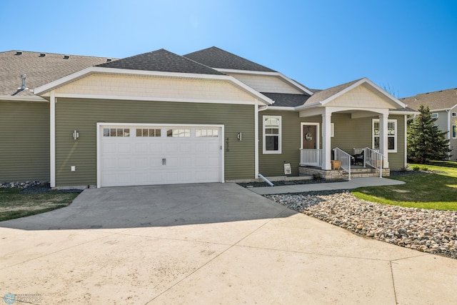ranch-style house with an attached garage, driveway, a shingled roof, and covered porch