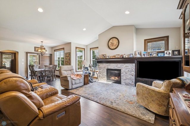 living room featuring a chandelier, vaulted ceiling, arched walkways, hardwood / wood-style floors, and recessed lighting