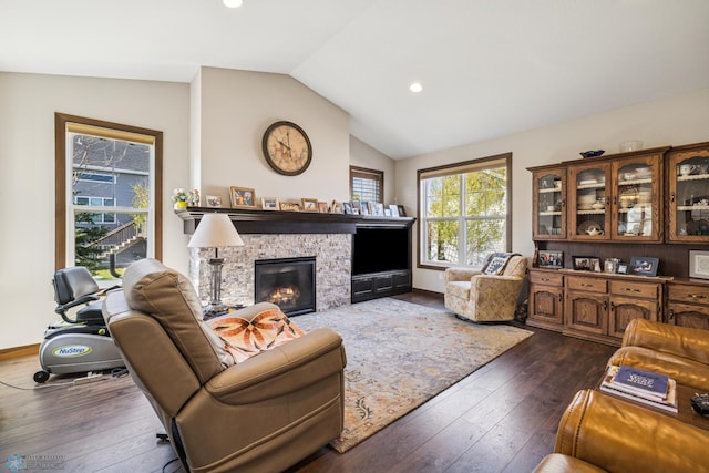 living room featuring vaulted ceiling, dark wood finished floors, recessed lighting, and a fireplace