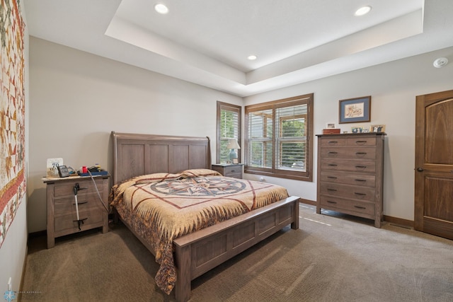 carpeted bedroom featuring a raised ceiling, recessed lighting, and baseboards