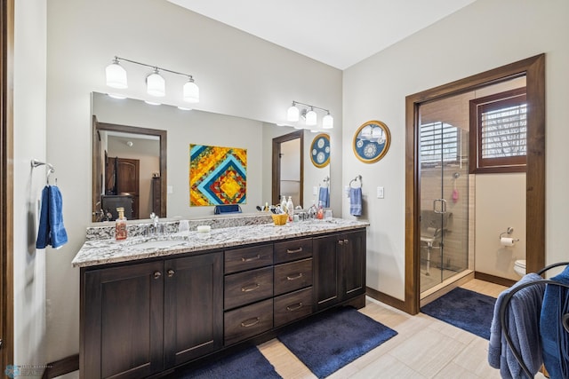 full bath featuring double vanity, toilet, and a stall shower