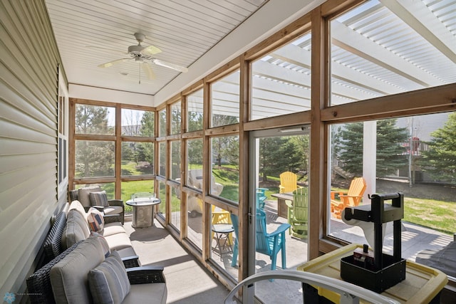 sunroom / solarium featuring a ceiling fan