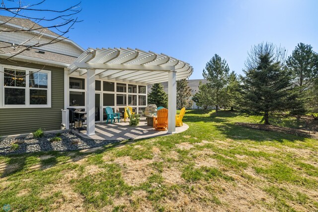 view of green lawn with a pergola and a patio area