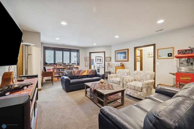 living room with light carpet and recessed lighting