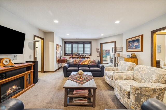 living room featuring recessed lighting, carpet, and baseboards