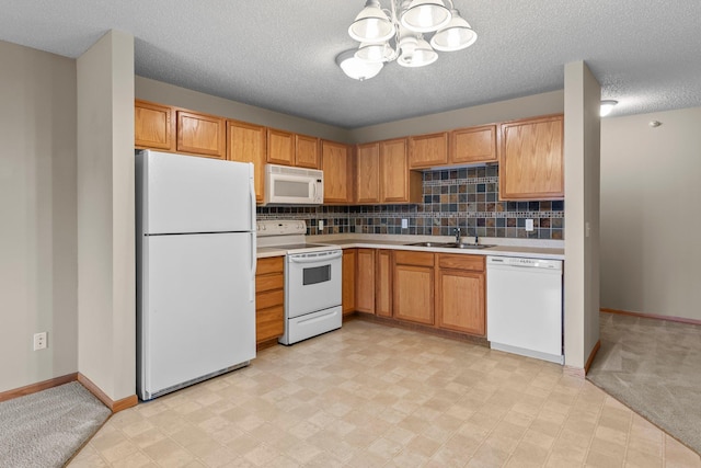 610 Whiskey Rd NW Unit 115, Isanti, MN 55040 - kitchen with white appliances, light countertops, a chandelier, backsplash, and a textured ceiling
