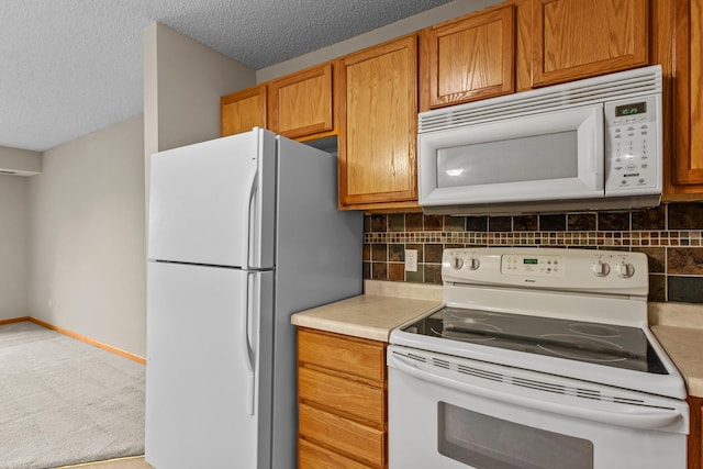 610 Whiskey Rd NW Unit 115, Isanti, MN 55040 - kitchen with white appliances, decorative backsplash, light countertops, brown cabinetry, and a textured ceiling