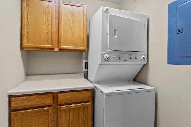 610 Whiskey Rd NW Unit 115, Isanti, MN 55040 - laundry room with stacked washer / drying machine, cabinet space, and electric panel