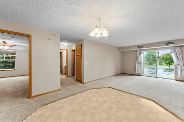 610 Whiskey Rd NW Unit 115, Isanti, MN 55040 - unfurnished living room featuring light carpet, a textured ceiling, a chandelier, and a ceiling fan