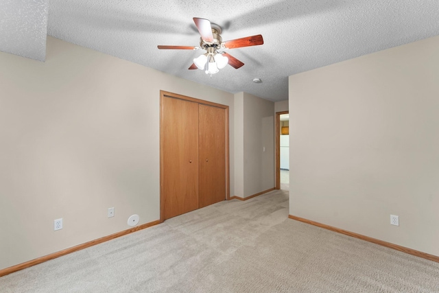 610 Whiskey Rd NW Unit 115, Isanti, MN 55040 - unfurnished bedroom with a textured ceiling, carpet flooring, a closet, and a ceiling fan