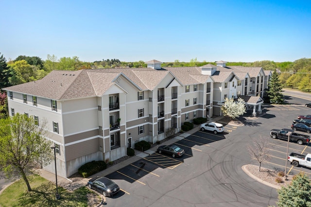 610 Whiskey Rd NW Unit 115, Isanti, MN 55040 - view of building exterior featuring uncovered parking