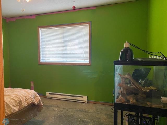 bedroom with a baseboard radiator and concrete floors