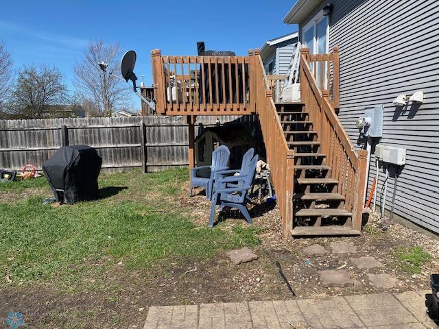 view of yard with stairway, fence, and a wooden deck