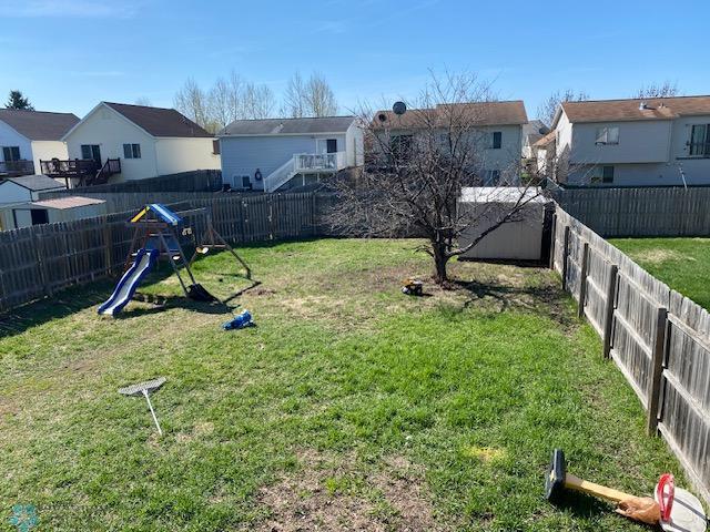 view of yard with a residential view and a playground
