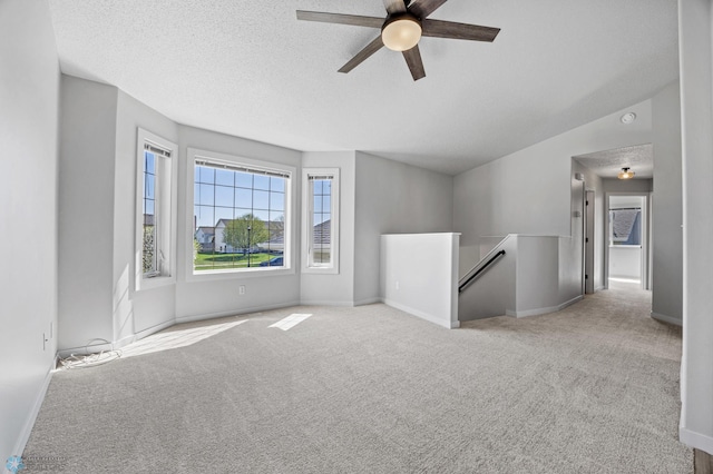 1683 Oakwood Dr, West Fargo, ND 58078 - unfurnished room featuring carpet, a ceiling fan, baseboards, and a textured ceiling