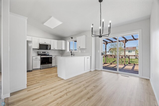 1683 Oakwood Dr, West Fargo, ND 58078 - kitchen featuring appliances with stainless steel finishes, a chandelier, light countertops, light wood-style flooring, and vaulted ceiling