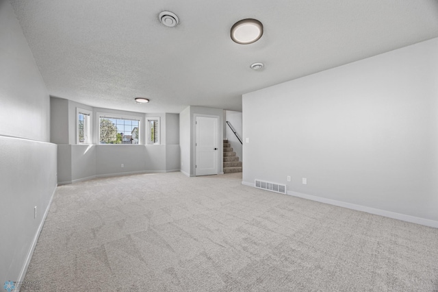 1683 Oakwood Dr, West Fargo, ND 58078 - carpeted spare room with stairs, baseboards, and a textured ceiling