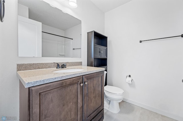 1683 Oakwood Dr, West Fargo, ND 58078 - bathroom featuring baseboards, toilet, vanity, and a shower