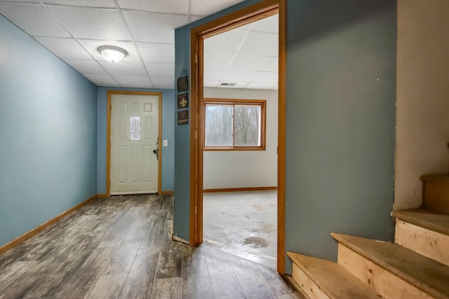 doorway with visible vents, baseboards, wood-type flooring, and a paneled ceiling