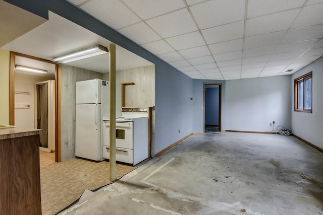 unfurnished living room with baseboards, a paneled ceiling, and concrete floors