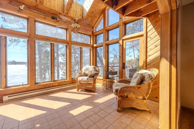 sunroom with a baseboard heating unit, a water view, tile patterned floors, high vaulted ceiling, and a skylight