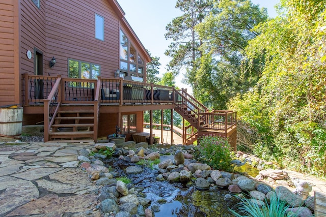 exterior space with stairs, a patio area, and a deck