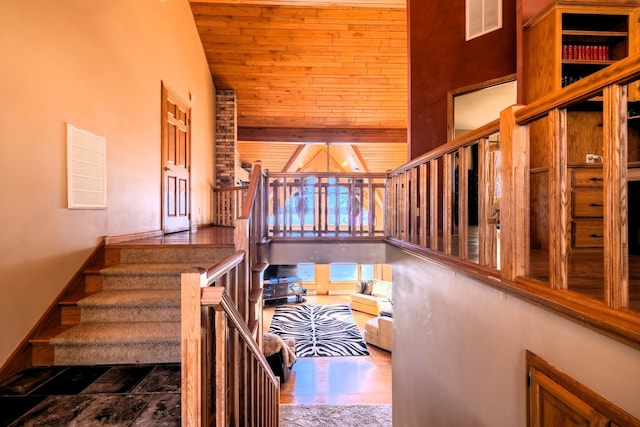 stairs featuring visible vents, high vaulted ceiling, and wood ceiling