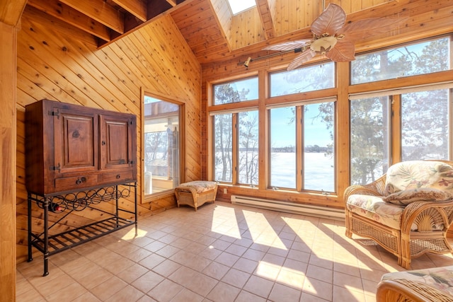 sunroom with a water view, wood walls, tile patterned flooring, vaulted ceiling, and a baseboard radiator