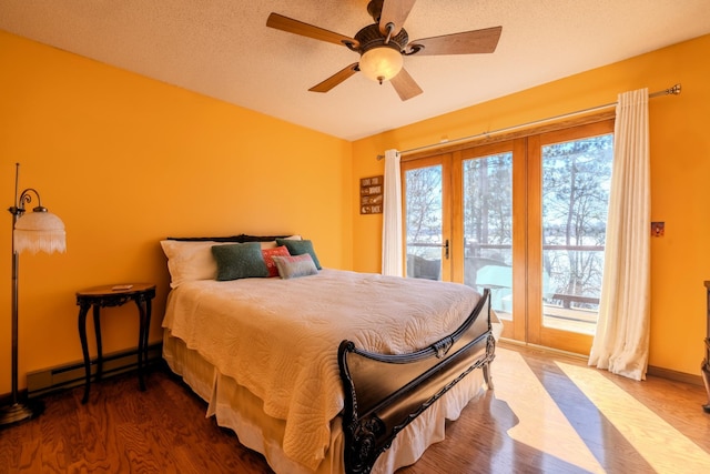 bedroom with wood finished floors, baseboards, a baseboard radiator, a ceiling fan, and access to outside