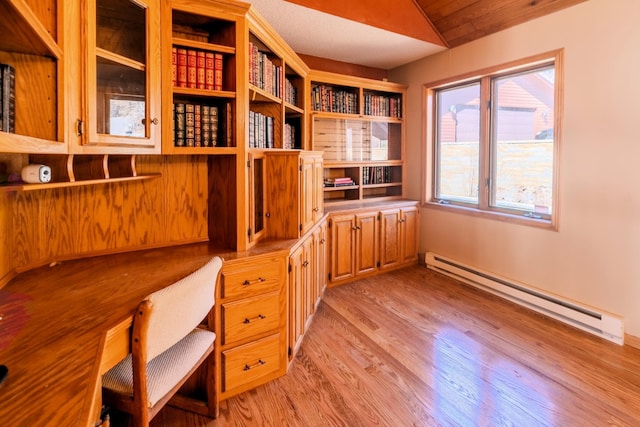 unfurnished office featuring light wood-style floors, baseboard heating, and built in study area