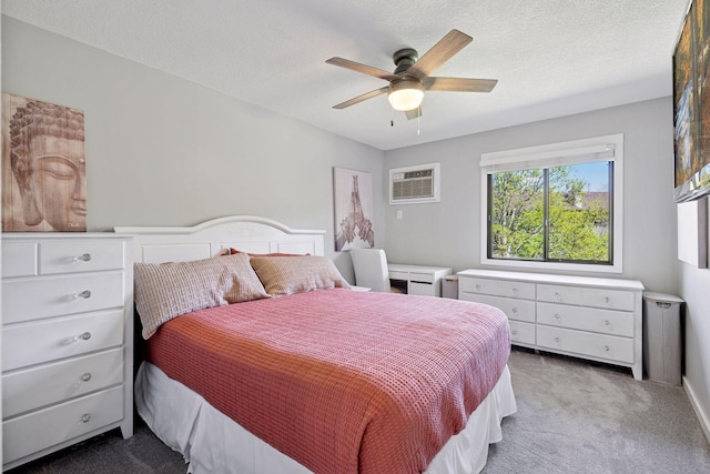 bedroom with carpet floors, a wall mounted AC, a ceiling fan, and a textured ceiling