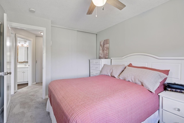bedroom featuring light carpet, a closet, and ceiling fan