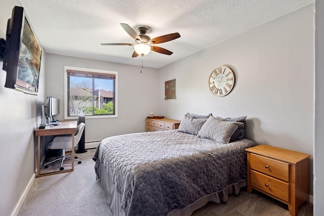 bedroom with carpet flooring, a desk, baseboards, a baseboard radiator, and a ceiling fan