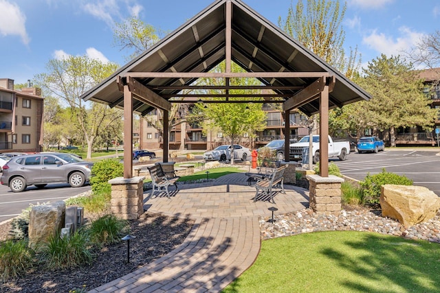 view of community featuring a gazebo and uncovered parking