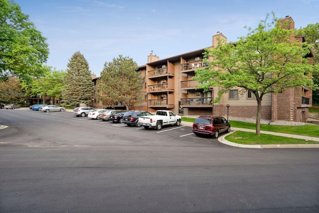 view of building exterior with uncovered parking