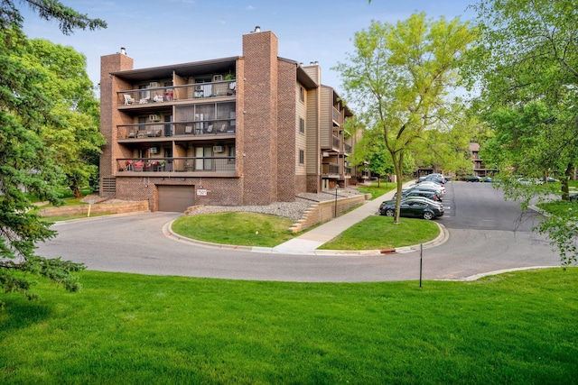 view of building exterior with a garage and driveway