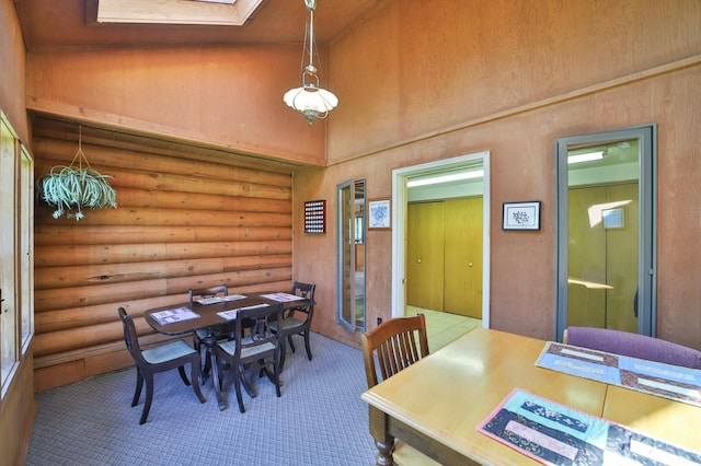24997 145th Ave, Fort Ripley, MN 56449 - dining room with a high ceiling, a skylight, log walls, and carpet flooring