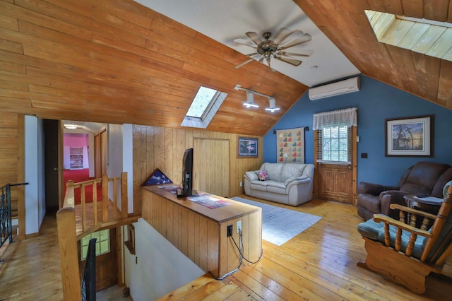 24997 145th Ave, Fort Ripley, MN 56449 - living room with a skylight, a wall mounted air conditioner, hardwood / wood-style floors, lofted ceiling, and a ceiling fan